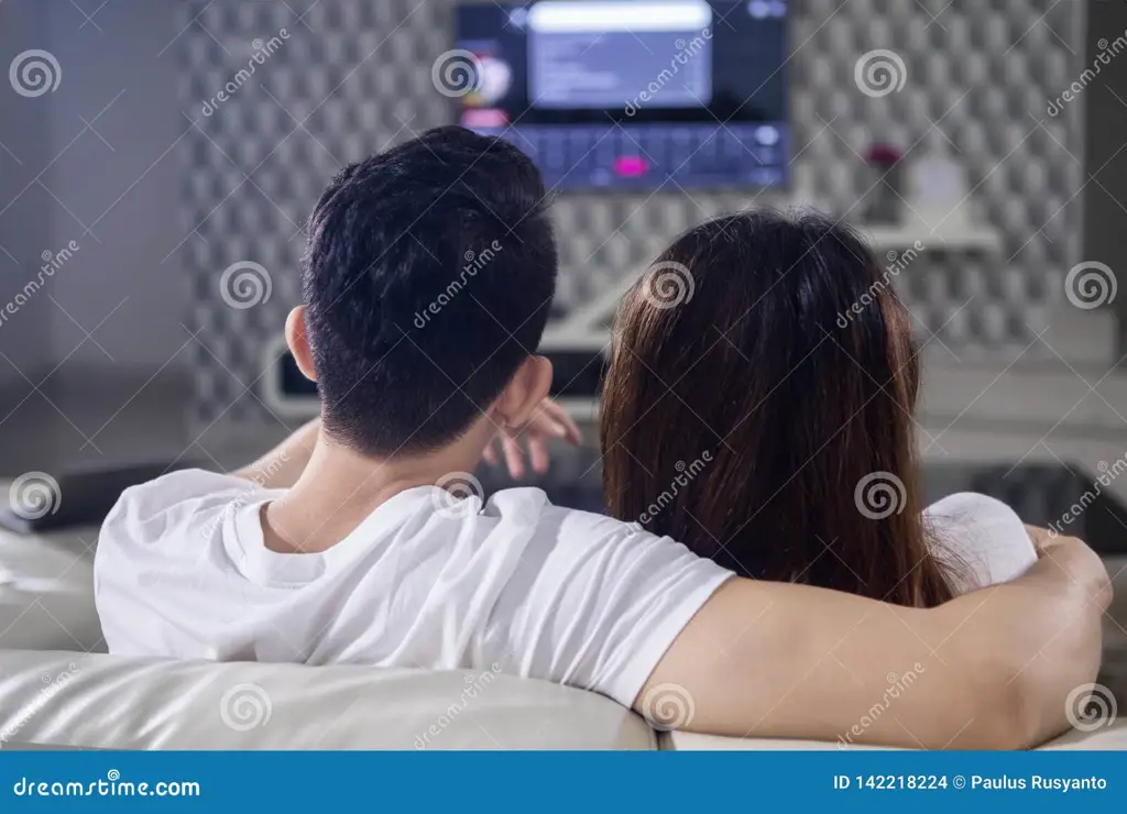 Pasangan romantis menonton televisi bersama