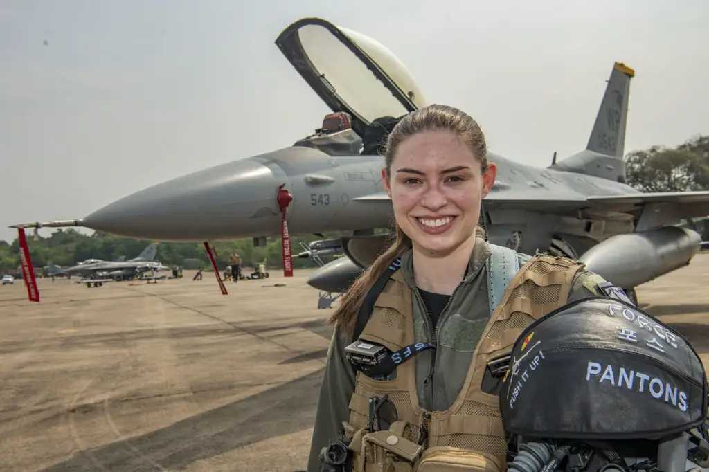 Pilot wanita angkatan udara sedang memeriksa pesawatnya